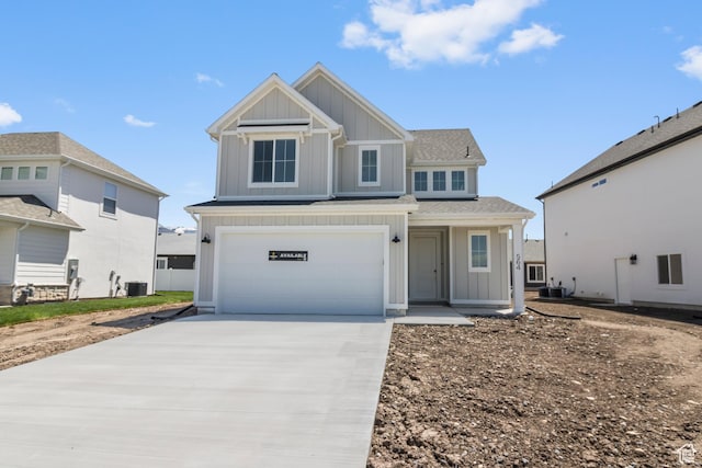 564 N 800 W, Smithfield, UT 84335 - view of front of house featuring board and batten siding, central AC, concrete driveway, an attached garage, and a shingled roof