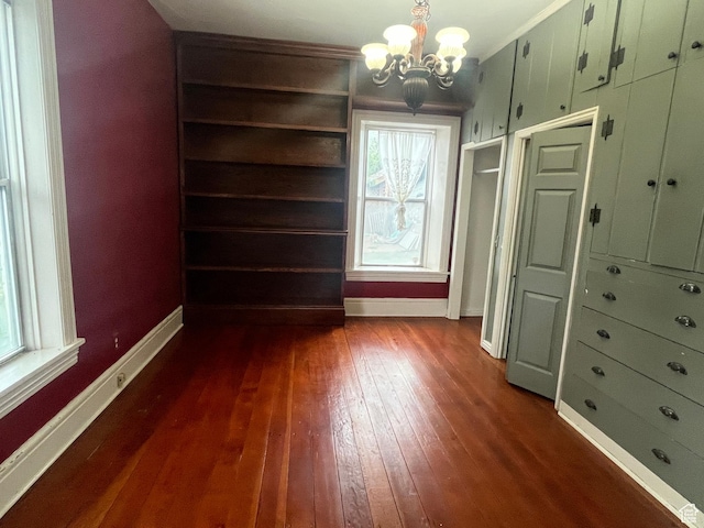 375 E 200 S, Centerville, UT 84014 - unfurnished dining area featuring dark wood finished floors, a chandelier, healthy amount of natural light, and baseboards