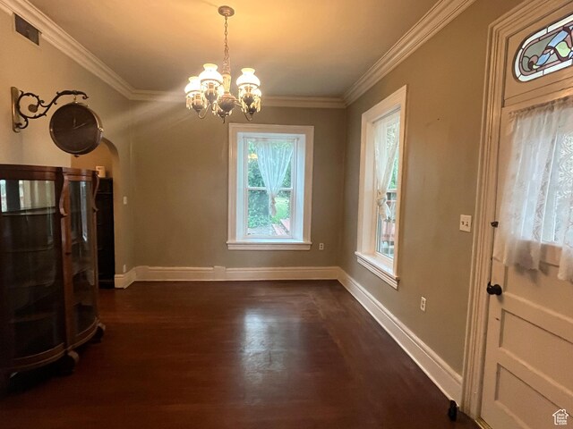 375 E 200 S, Centerville, UT 84014 - unfurnished living room with a chandelier, arched walkways, dark wood finished floors, ornamental molding, and baseboards