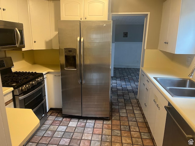 375 E 200 S, Centerville, UT 84014 - kitchen with stainless steel appliances, a sink, white cabinetry, and light countertops