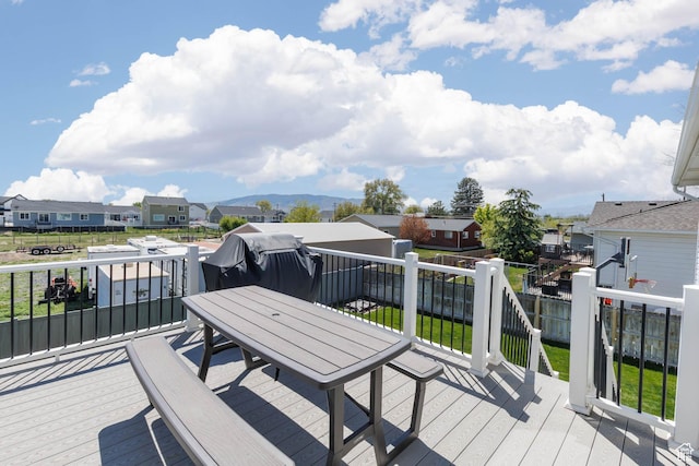 deck featuring a residential view, outdoor dining space, and fence