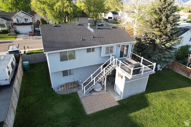 rear view of property with stairs, a wooden deck, and a shingled roof