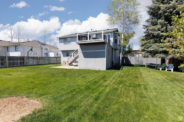 rear view of house featuring a balcony and stairs