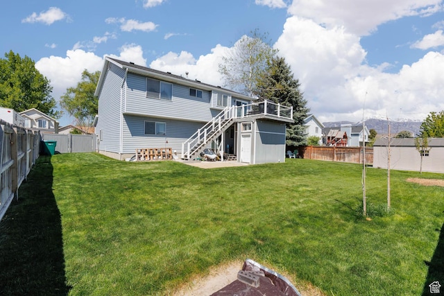 rear view of property featuring stairs and a wooden deck
