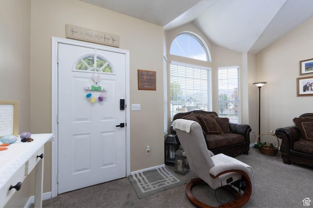 foyer entrance with carpet flooring, lofted ceiling, and baseboards