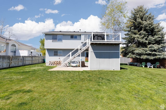 rear view of property featuring stairs and a wooden deck