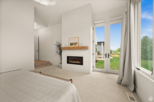 10076 S Wild Goose Cv E, Sandy, UT 84092 - carpeted bedroom featuring access to exterior, a glass covered fireplace, and a chandelier