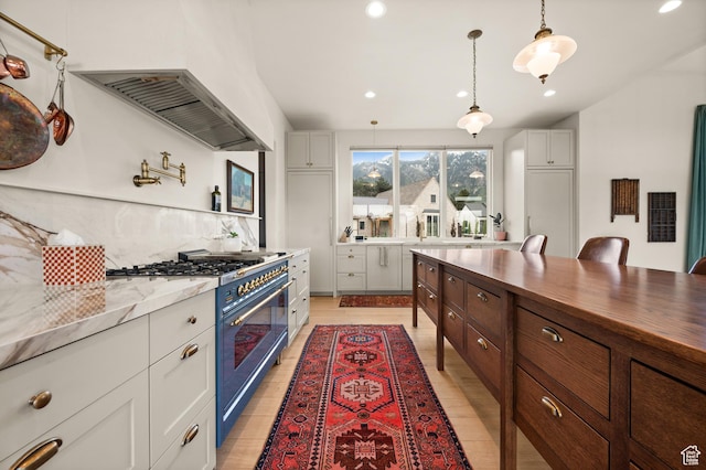 10076 S Wild Goose Cv E, Sandy, UT 84092 - kitchen featuring double oven range, extractor fan, tasteful backsplash, recessed lighting, and hanging light fixtures