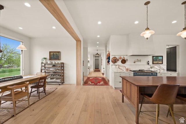 10076 S Wild Goose Cv E, Sandy, UT 84092 - kitchen featuring range with gas stovetop, light wood finished floors, white cabinets, recessed lighting, and tasteful backsplash