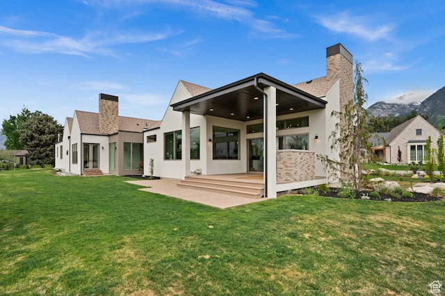 10076 S Wild Goose Cv E, Sandy, UT 84092 - back of house with a chimney, french doors, and stucco siding
