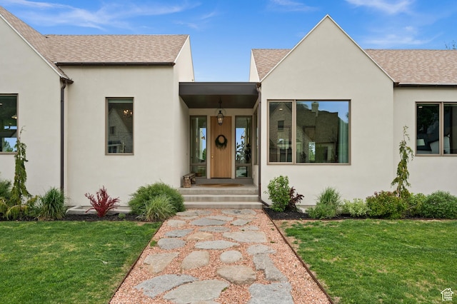10076 S Wild Goose Cv E, Sandy, UT 84092 - view of front of home featuring roof with shingles, a front yard, and stucco siding