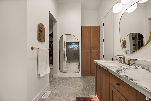 10076 S Wild Goose Cv E, Sandy, UT 84092 - bathroom featuring vanity, baseboards, and a spacious closet