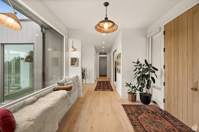 10076 S Wild Goose Cv E, Sandy, UT 84092 - hall featuring light wood-type flooring, baseboards, recessed lighting, and wooden walls
