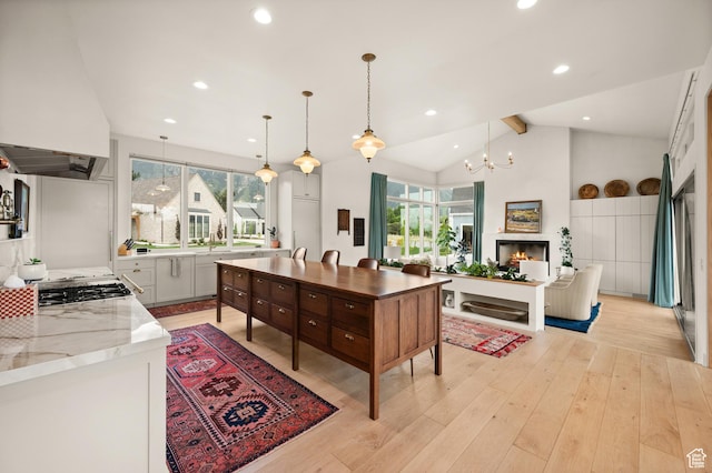 10076 S Wild Goose Cv E, Sandy, UT 84092 - kitchen with custom exhaust hood, plenty of natural light, light wood-style flooring, decorative light fixtures, and recessed lighting