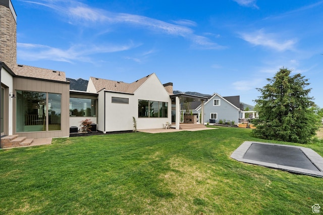 10076 S Wild Goose Cv E, Sandy, UT 84092 - rear view of property featuring a lawn and a patio