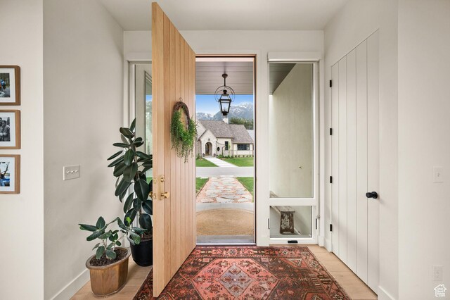 10076 S Wild Goose Cv E, Sandy, UT 84092 - doorway to outside featuring baseboards