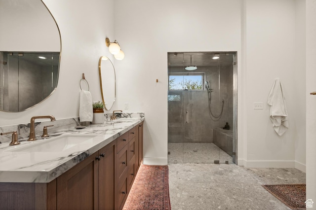 10076 S Wild Goose Cv E, Sandy, UT 84092 - bathroom featuring baseboards, a stall shower, and double vanity