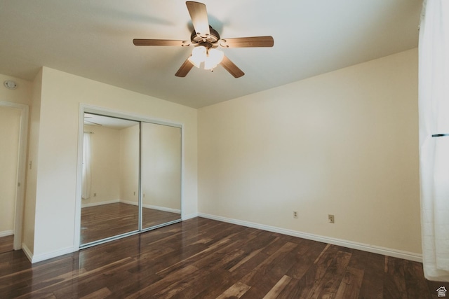 unfurnished bedroom featuring wood finished floors, a closet, baseboards, and ceiling fan
