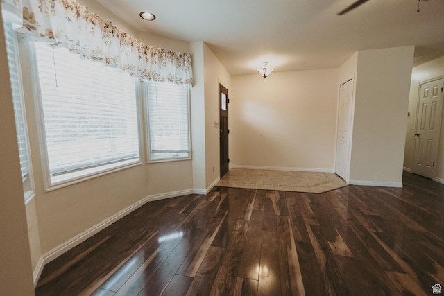 unfurnished dining area with wood-type flooring, baseboards, and a ceiling fan