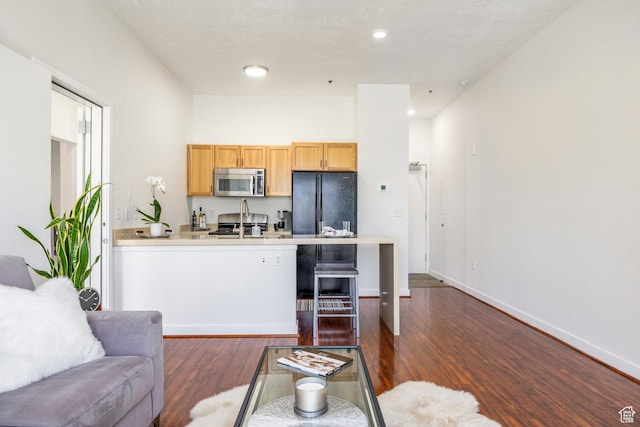 living room featuring dark wood finished floors, baseboards, and recessed lighting