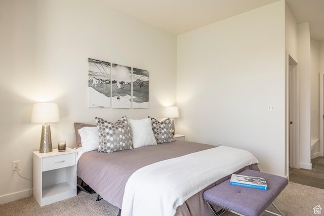 bedroom with baseboards and light carpet