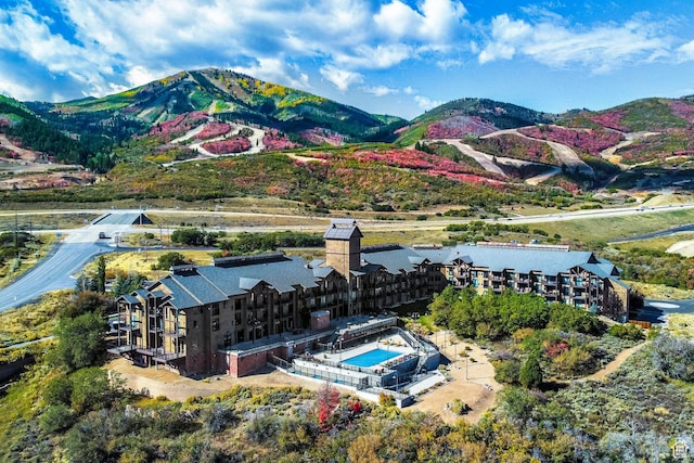 drone / aerial view of a pool and a mountainous background