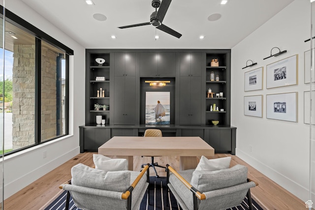 office with built in shelves, baseboards, a ceiling fan, light wood finished floors, and recessed lighting