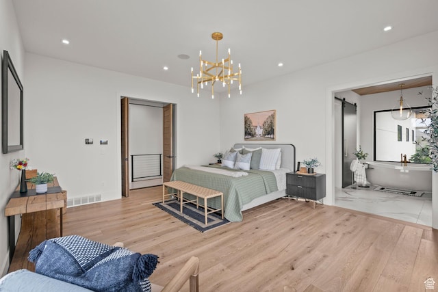 bedroom with a chandelier, wood finished floors, and recessed lighting