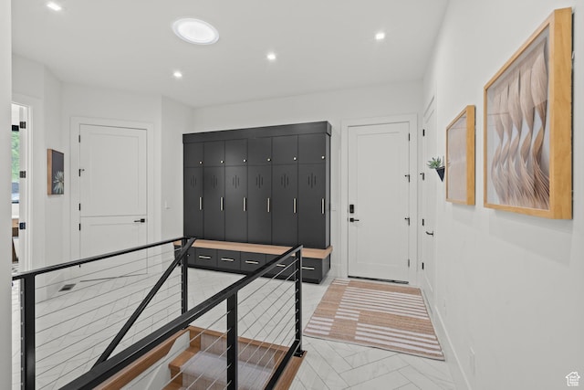 foyer with recessed lighting and baseboards