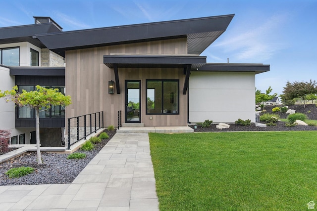 doorway to property with a yard