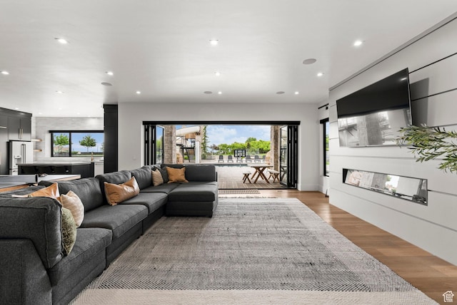 living area with recessed lighting and light wood-type flooring