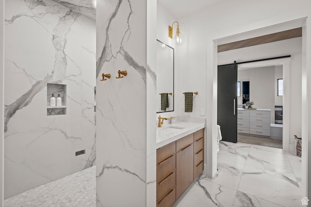 bathroom with vanity, marble tiled flooring, and a marble finish shower