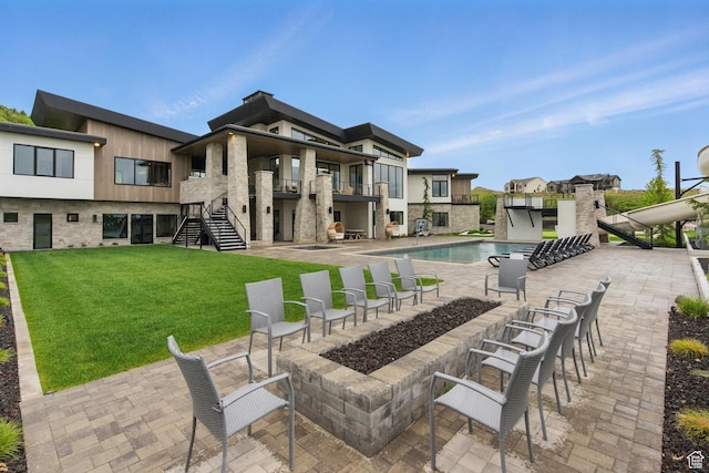 view of patio / terrace featuring stairs, a balcony, and an outdoor pool