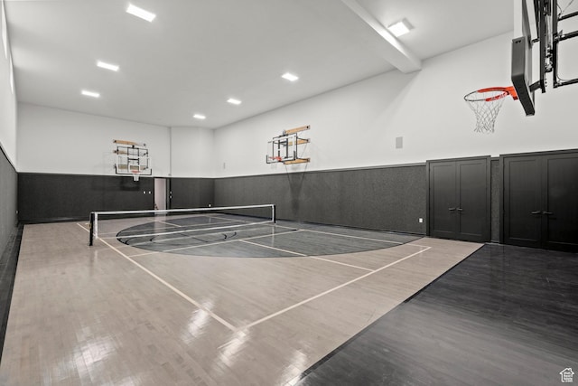 view of basketball court featuring community basketball court, a tennis court, and fence