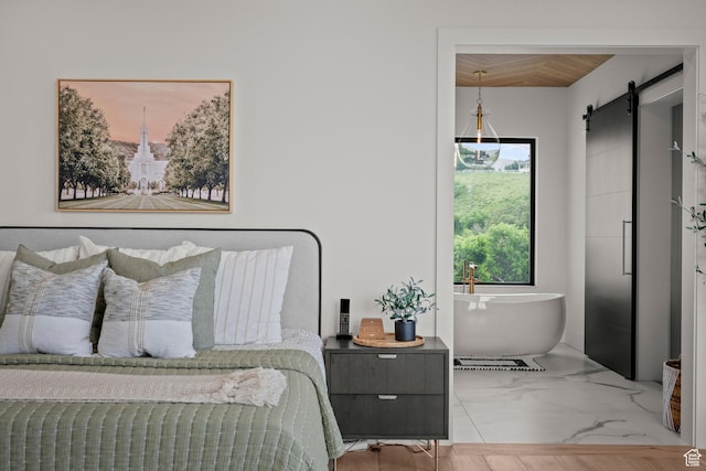 bedroom with a barn door and wood ceiling