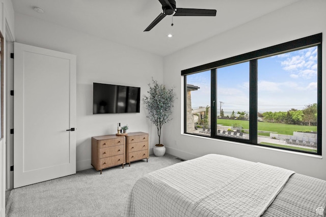 bedroom featuring light carpet, a ceiling fan, recessed lighting, and baseboards
