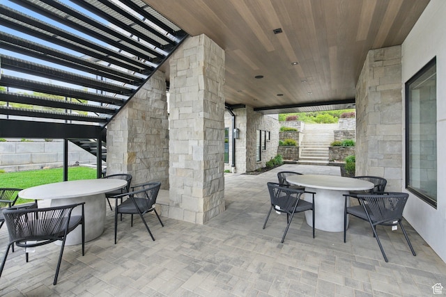 view of patio / terrace with outdoor dining space, stairs, a pergola, and fence