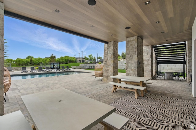 view of patio / terrace featuring outdoor dining area, an outdoor pool, and fence