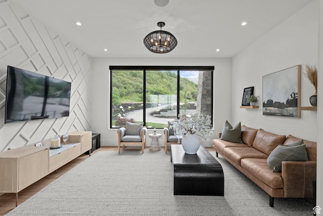 living room with a chandelier, wood finished floors, and recessed lighting