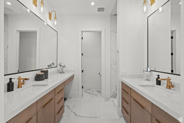 bathroom with marble finish flooring, two vanities, baseboards, and recessed lighting