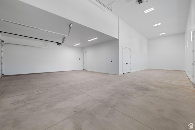garage featuring a garage door opener and baseboards