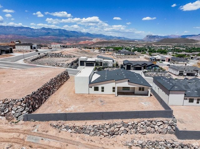 aerial view of residential area featuring mountains