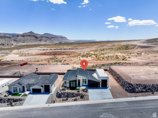 aerial view of property and surrounding area with a mountainous background and a desert landscape