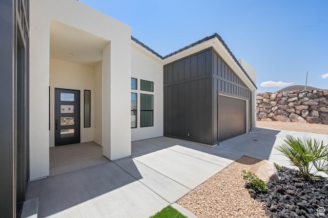 entrance to property featuring stucco siding