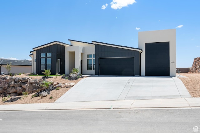contemporary home with a garage, board and batten siding, and driveway
