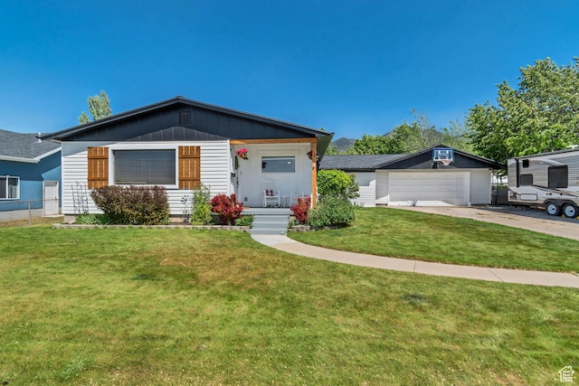 120 N 5th St, Tooele, UT 84074 - ranch-style home with a garage, concrete driveway, an outdoor structure, board and batten siding, and a porch