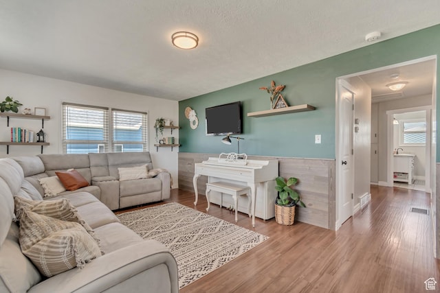 120 N 5th St, Tooele, UT 84074 - living room with a wainscoted wall, wood finished floors, and a textured ceiling