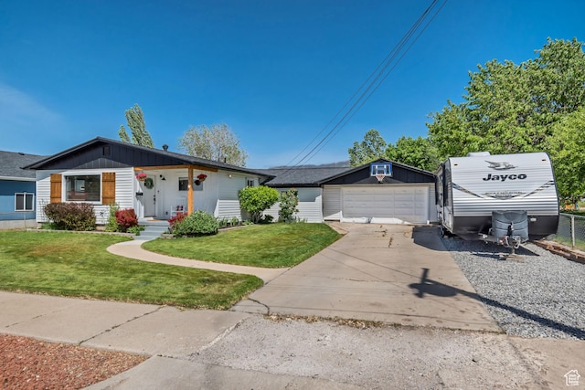 120 N 5th St, Tooele, UT 84074 - view of front facade with an outdoor structure, a front lawn, covered porch, and a detached garage