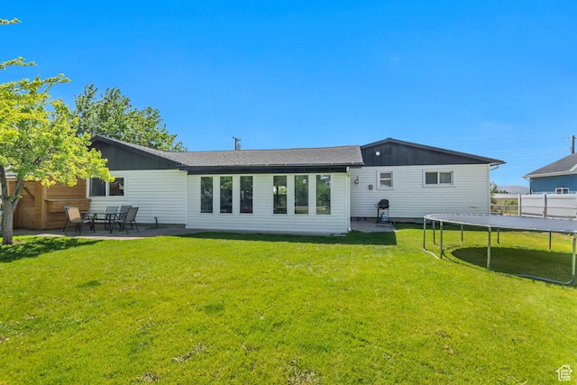 120 N 5th St, Tooele, UT 84074 - back of property featuring board and batten siding, a trampoline, and a patio