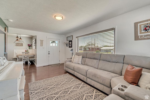 120 N 5th St, Tooele, UT 84074 - living room with dark wood finished floors, a textured ceiling, and baseboards